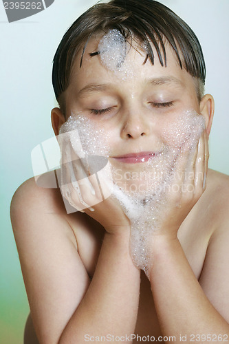 Image of Young boy child washing cleansing face soap and water