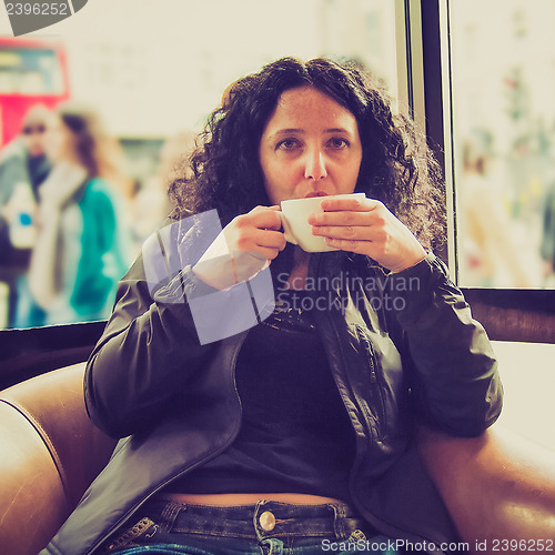 Image of Pretty brunette drinking coffee tea