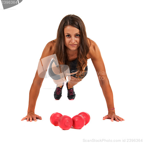 Image of Young woman in the studio with weights