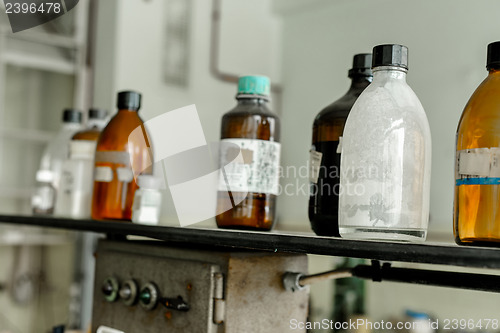 Image of Photo of an old laboratory with a lot of bottles
