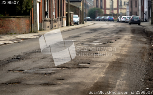 Image of Damaged car road with a lot of cracks