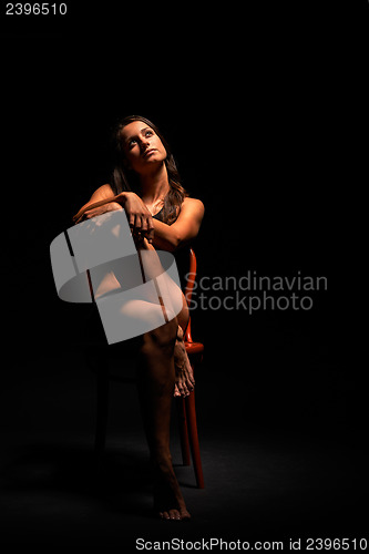 Image of Young muscular woman under bright light