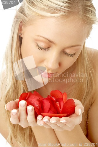 Image of lovely blond in spa with red rose petals