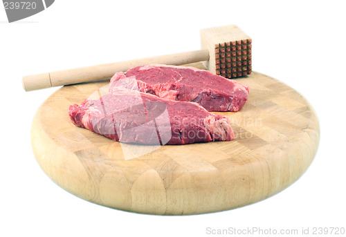 Image of Steaks on a chopping board with Mallet