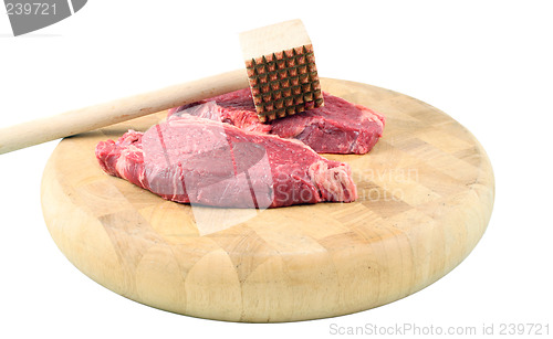 Image of Steaks on a chopping board with Mallet