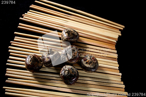 Image of water chestnuts on chopsticks