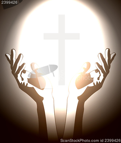 Image of hand and christian cross silhouette