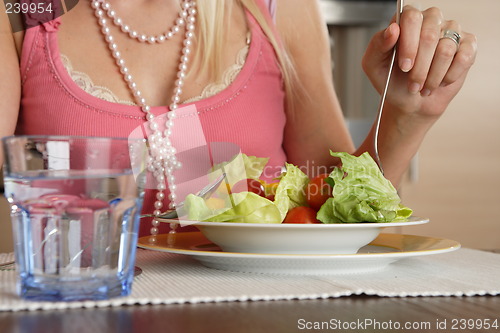 Image of Woman eating salad