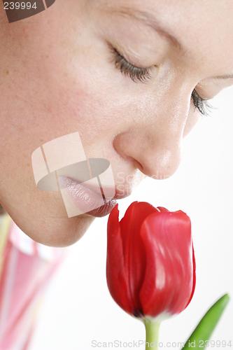 Image of Woman smelling flower
