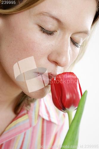 Image of Woman smelling flower