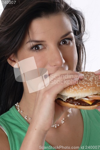 Image of Woman eating burger