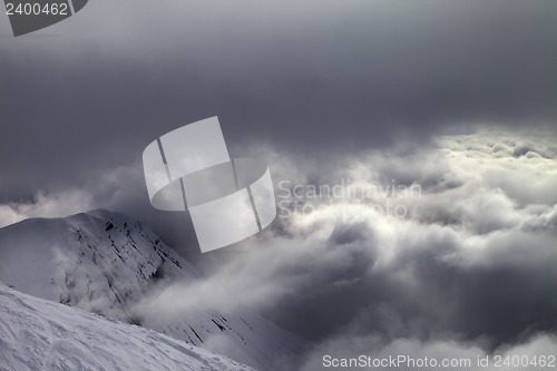 Image of Off-piste slope and snowy rocks in bad weather