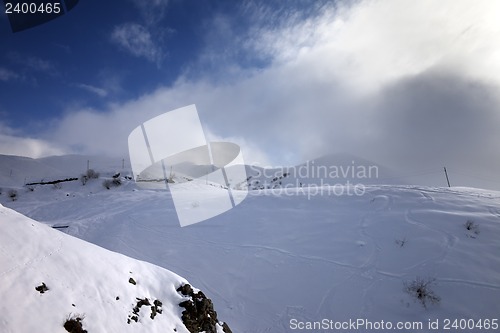 Image of Off-piste slope and mountains in haze