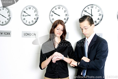 Image of Business executives checking time