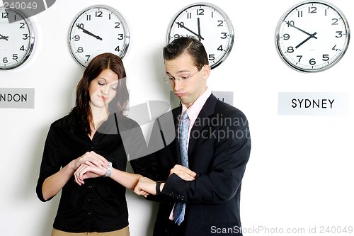 Image of Business executives checking time