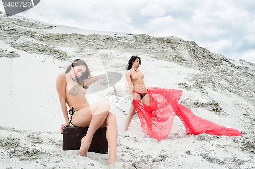 Image of Attractive naked girls on sand