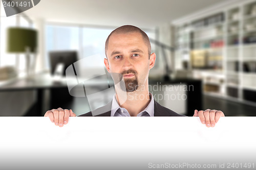 Image of Businessman showing blank empty white billboard sign