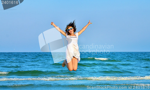 Image of Jumping happy girl on the beach