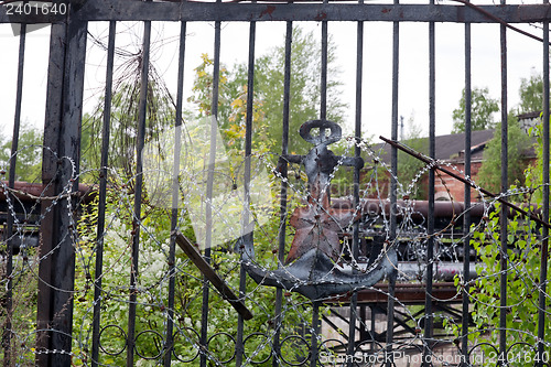 Image of old rusty soviet gate to marine base