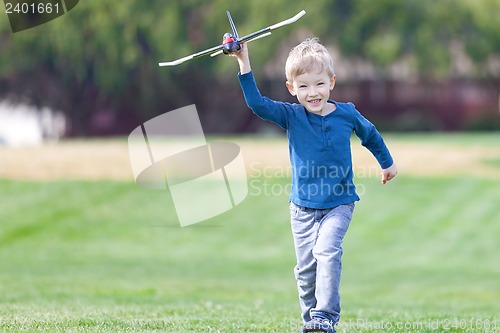Image of boy playing toy plane