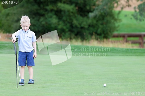 Image of boy playing golf
