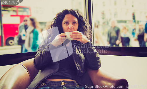 Image of Pretty brunette drinking coffee tea