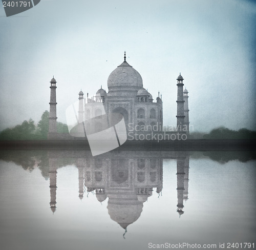 Image of Taj Mahal in twilight trough the fog with water reflection