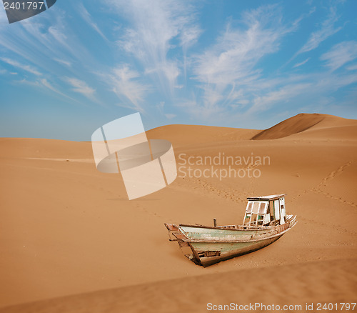 Image of Old boat among the sand dunes in the desert