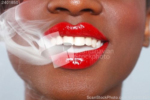 Image of Beautiful Lips of a Woman With Cigarette Smoke