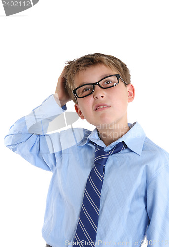Image of Schoolboy scratching head while thinking and looking up
