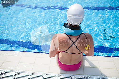 Image of Female swimmer at pool edge