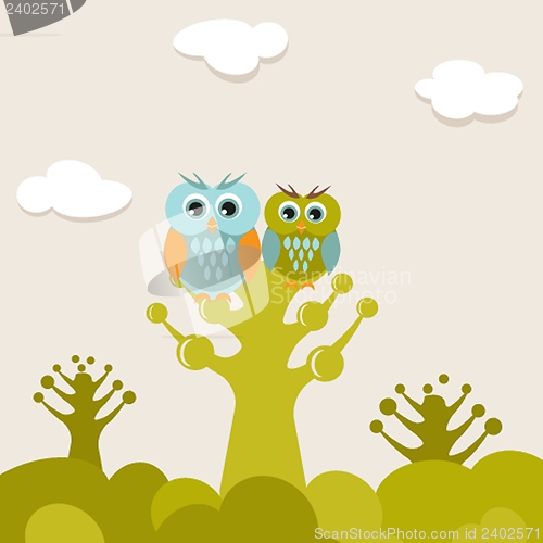 Image of Two cute owls on the tree branch