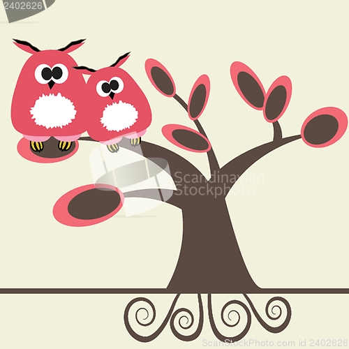 Image of Two cute owls on the tree branch