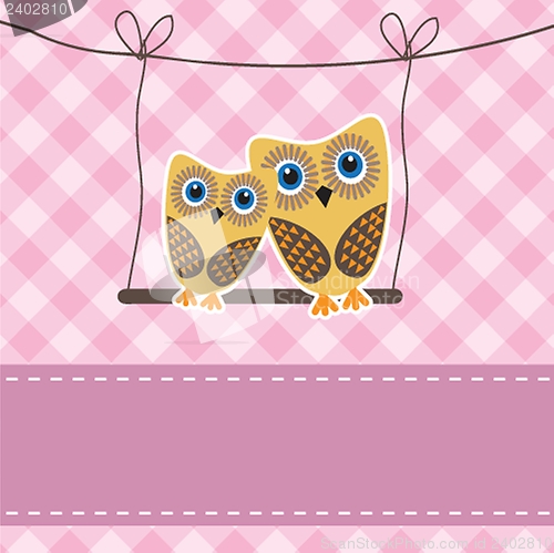 Image of Two cute owls on the tree branch