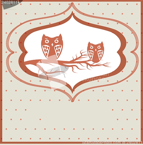 Image of Two cute owls on the tree branch