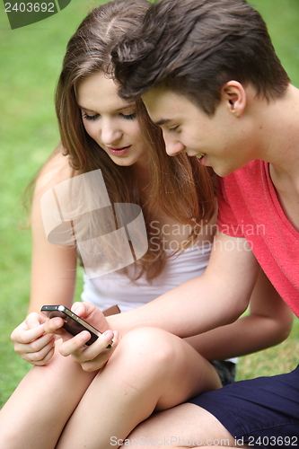 Image of Young students reading a text message