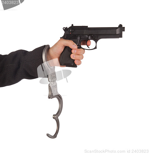 Image of Businessman with gun and handcuffs