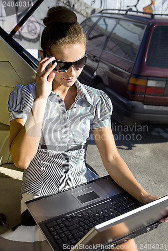 Image of woman has a fan with laptop computer