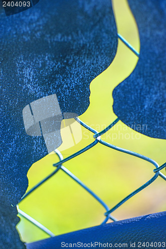 Image of hole in a fence