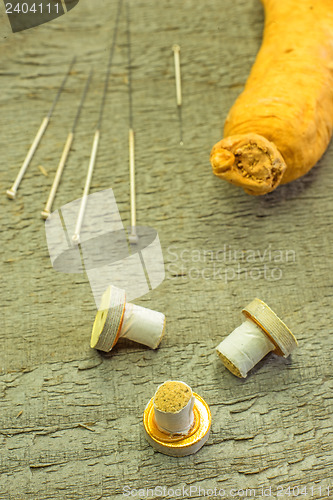 Image of acupuncture needles, moxibustion cones and ginseng root