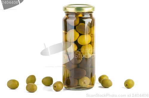 Image of Glass jar with green and black olives . Some near