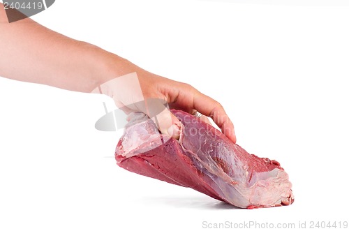 Image of Hand take raw veal slab