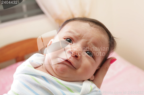 Image of Woman holding a beautiful sweet hispanic newborn crying 