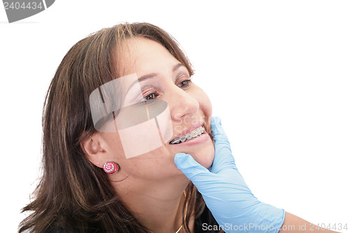 Image of Woman checking his routine brackets on her dentist