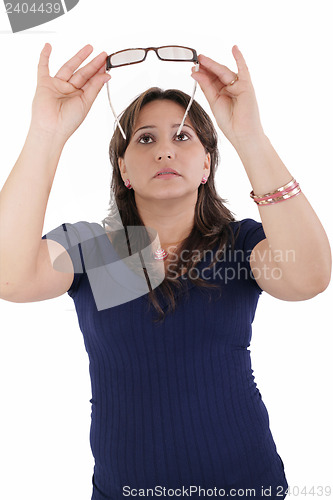 Image of hispanic young woman checking her eyeglasses