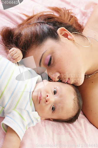 Image of Hispanic woman kissing newborn 