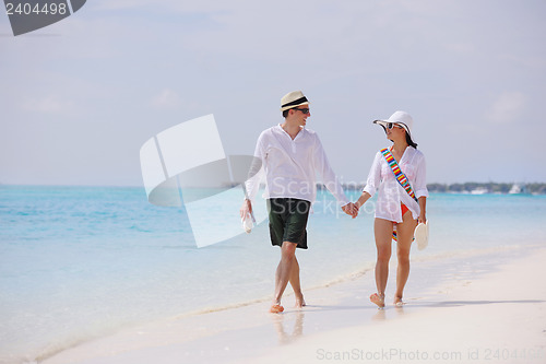 Image of happy young couple have fun on beach