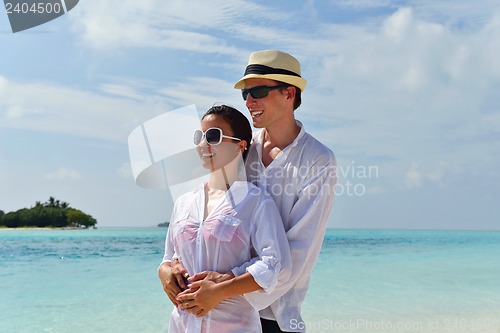 Image of happy young couple have fun on beach