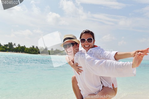 Image of happy young couple have fun on beach