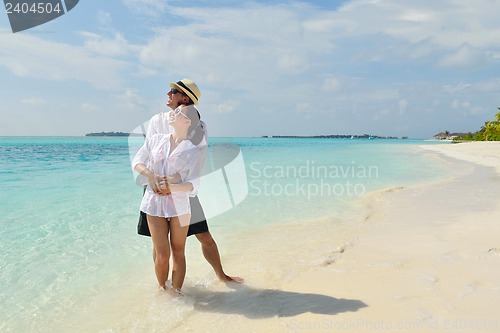 Image of happy young couple have fun on beach